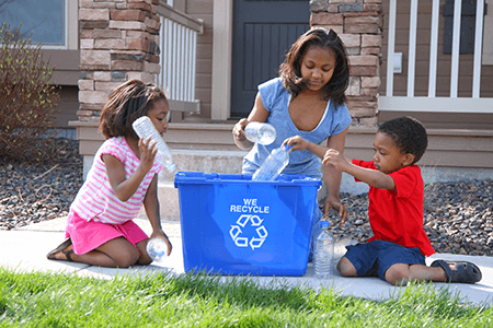 Family Outside Recycling Plastic Bottles