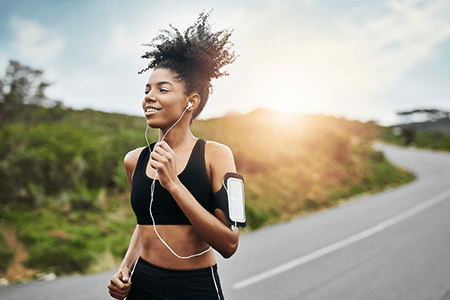 Athletic Woman Jogging with Headphones and Cellphone